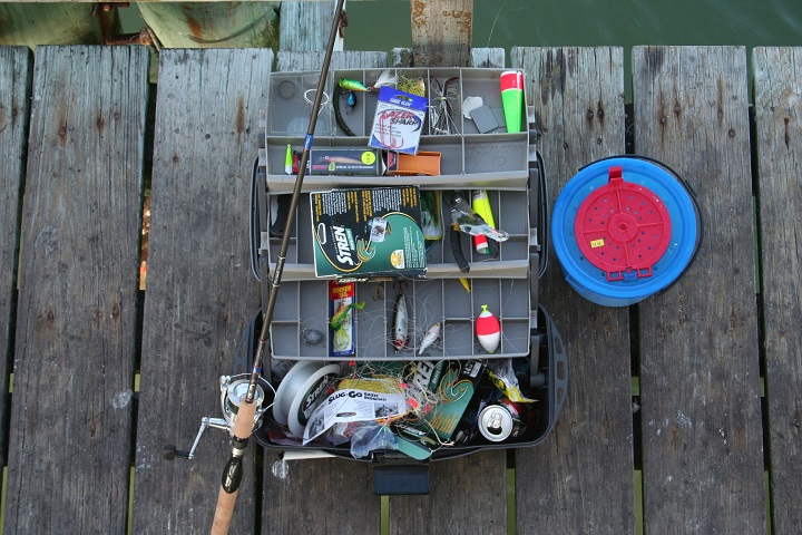 fishing tackle box on wooden bridge